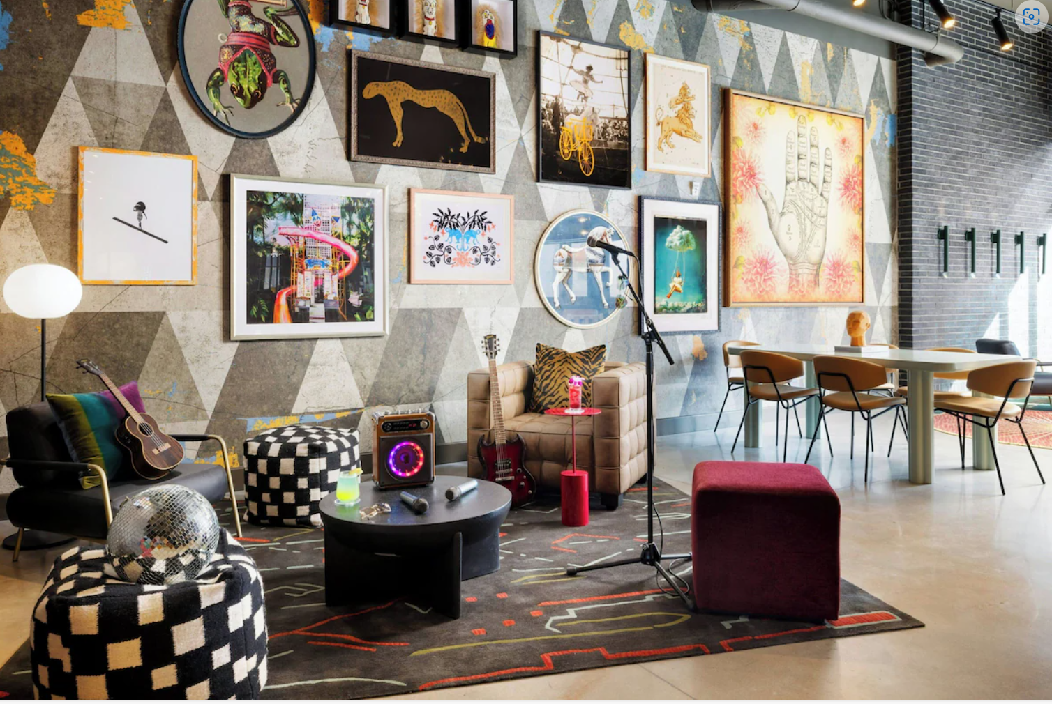Moxy Allentown lobby lounge with guitar, microphone, and eclectic art